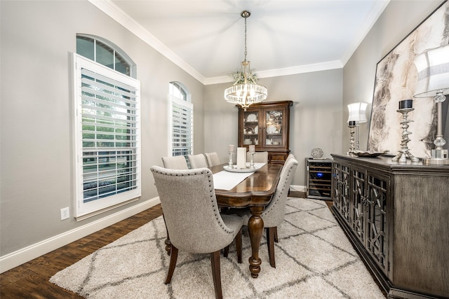 8230 Carter St, Lantana, TX 76226 - dining space with a chandelier, ornamental molding, wine cooler, baseboards, and wood finished floors
