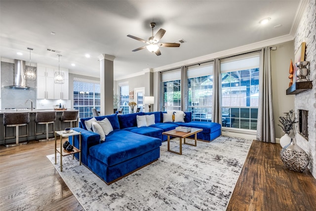 8230 Carter St, Lantana, TX 76226 - living room featuring crown molding, light wood-style floors, a ceiling fan, a fireplace, and recessed lighting