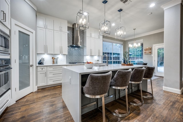 8230 Carter St, Lantana, TX 76226 - kitchen featuring wall chimney exhaust hood, a sink, a chandelier, dark wood-type flooring, and recessed lighting