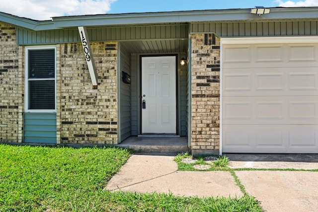 1509 Cedar Keys Dr, Lewisville, TX 75067 - doorway to property with brick siding, driveway, and a garage