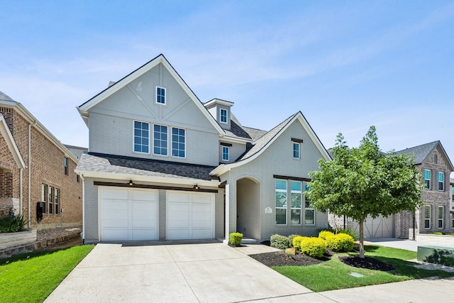 927 Leola Ln, Allen, TX 75013 - view of front of house with concrete driveway, brick siding, a garage, and a shingled roof