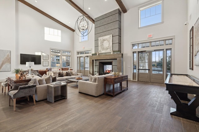 927 Leola Ln, Allen, TX 75013 - living area with high vaulted ceiling, beam ceiling, wood finished floors, a chandelier, and a multi sided fireplace