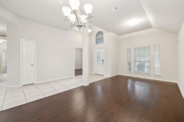 912 Kittery Dr, Desoto, TX 75115 - unfurnished living room with light wood-style flooring, vaulted ceiling, a chandelier, and baseboards