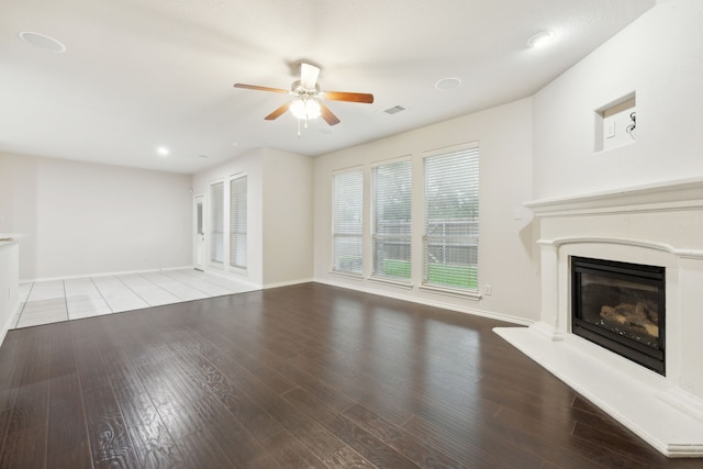 912 Kittery Dr, Desoto, TX 75115 - unfurnished living room featuring ceiling fan, a glass covered fireplace, wood finished floors, baseboards, and recessed lighting