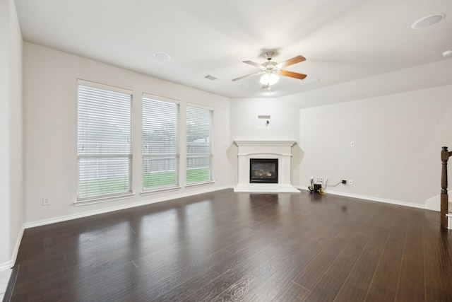 912 Kittery Dr, Desoto, TX 75115 - unfurnished living room featuring a ceiling fan, a glass covered fireplace, baseboards, and dark wood-style floors