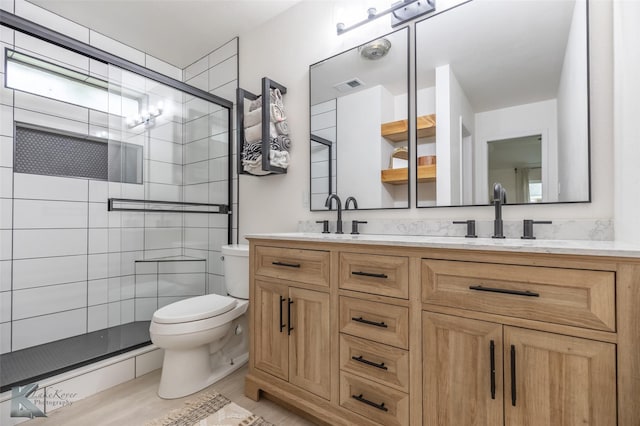 1518 Weavers Way, Abilene, TX 79602 - full bath featuring double vanity, a stall shower, toilet, and wood finished floors