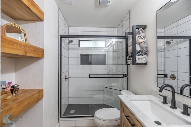 1518 Weavers Way, Abilene, TX 79602 - bathroom with toilet, a shower stall, vanity, and a textured wall