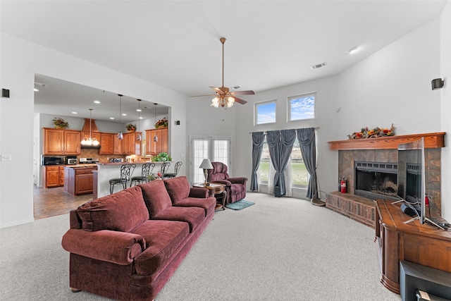 1114 Mount Ln, Rhome, TX 76078 - living area featuring carpet flooring, a ceiling fan, a tile fireplace, recessed lighting, and baseboards