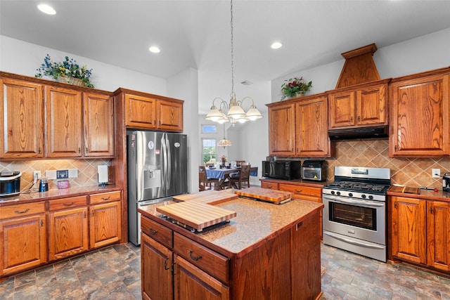1114 Mount Ln, Rhome, TX 76078 - kitchen with appliances with stainless steel finishes, under cabinet range hood, brown cabinetry, and recessed lighting
