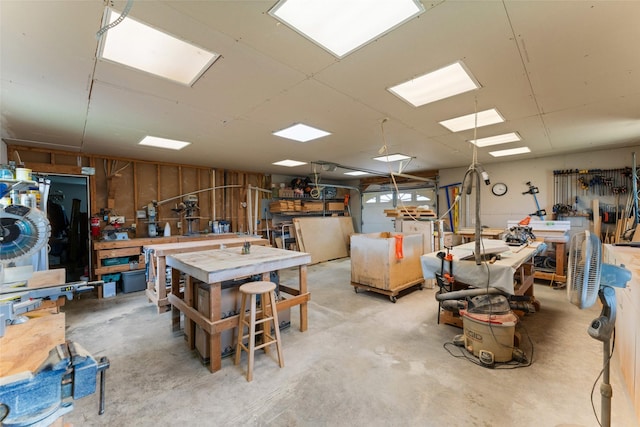 1114 Mount Ln, Rhome, TX 76078 - miscellaneous room featuring a workshop area and unfinished concrete floors