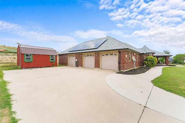 1114 Mount Ln, Rhome, TX 76078 - view of side of property with solar panels, brick siding, driveway, an attached garage, and a yard