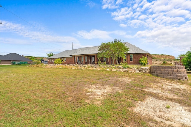 1114 Mount Ln, Rhome, TX 76078 - rear view of house featuring a lawn and brick siding