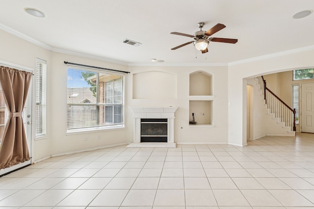 5723 Green Hollow Ln, The Colony, TX 75056 - unfurnished living room featuring crown molding, built in features, stairway, a ceiling fan, and a glass covered fireplace