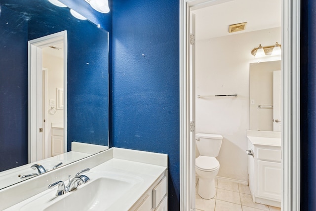5723 Green Hollow Ln, The Colony, TX 75056 - bathroom with tile patterned floors, toilet, vanity, and baseboards