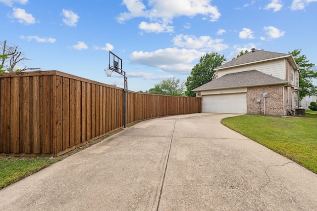 5723 Green Hollow Ln, The Colony, TX 75056 - view of home's exterior with brick siding, driveway, roof with shingles, and an attached garage