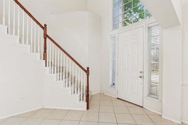 5723 Green Hollow Ln, The Colony, TX 75056 - foyer entrance with healthy amount of natural light, stairway, light tile patterned floors, and a towering ceiling