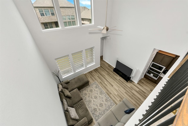 6329 Camey Place Way, The Colony, TX 75056 - unfurnished living room with a high ceiling, light wood-style floors, and a ceiling fan