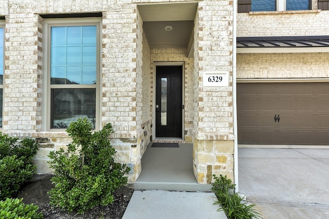 6329 Camey Place Way, The Colony, TX 75056 - entrance to property featuring a standing seam roof, metal roof, stone siding, and brick siding