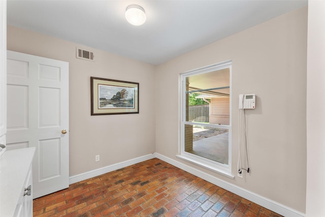 310 Northview Dr, Richardson, TX 75080 - spare room with baseboards and brick flooring