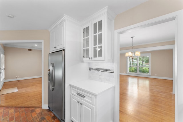 310 Northview Dr, Richardson, TX 75080 - kitchen featuring stainless steel fridge, white cabinets, glass insert cabinets, decorative backsplash, and baseboards