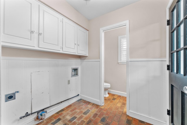 310 Northview Dr, Richardson, TX 75080 - laundry room featuring cabinet space, hookup for an electric dryer, wainscoting, brick floors, and baseboards