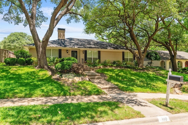 310 Northview Dr, Richardson, TX 75080 - ranch-style house with a chimney and brick siding
