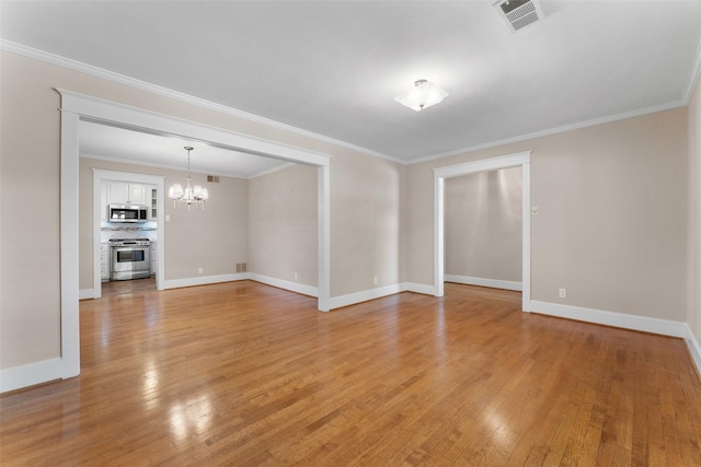 310 Northview Dr, Richardson, TX 75080 - spare room with a chandelier, light wood finished floors, baseboards, and crown molding