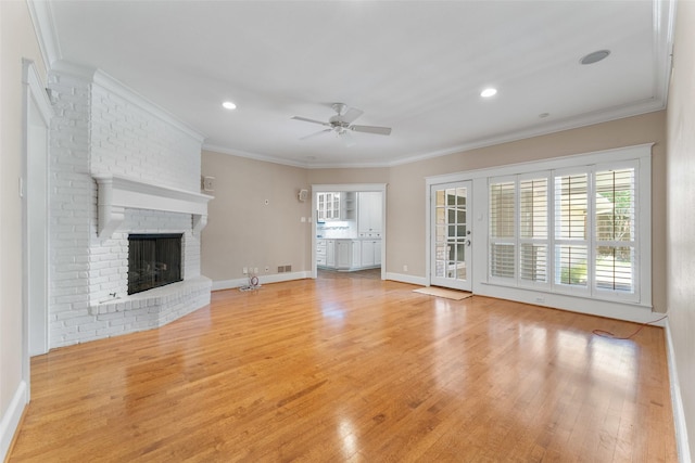 310 Northview Dr, Richardson, TX 75080 - unfurnished living room with ceiling fan, light wood-type flooring, a brick fireplace, crown molding, and recessed lighting