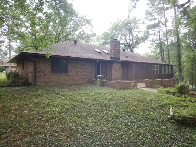 9217 Rhett Cir, Shreveport, LA 71118 - rear view of house featuring brick siding and a chimney