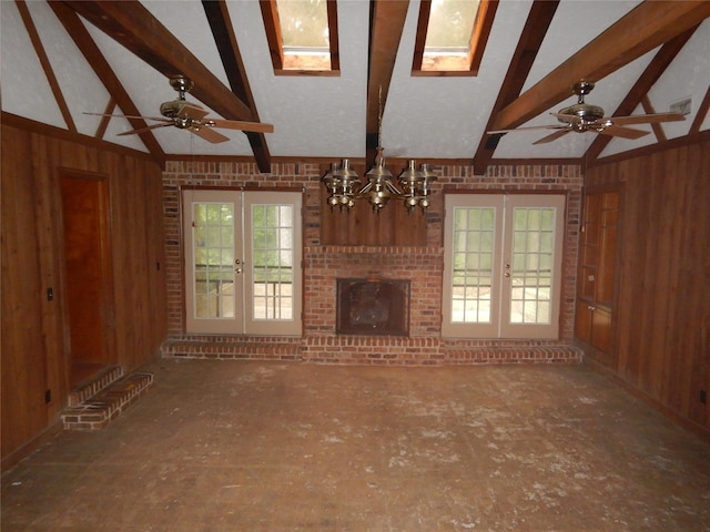 9217 Rhett Cir, Shreveport, LA 71118 - unfurnished living room featuring french doors, wooden walls, a skylight, beamed ceiling, and a chandelier