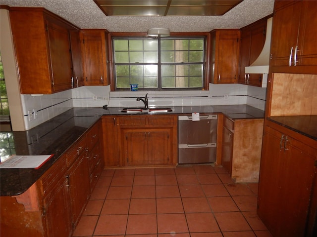 9217 Rhett Cir, Shreveport, LA 71118 - kitchen featuring a sink, dishwasher, brown cabinets, and light tile patterned floors