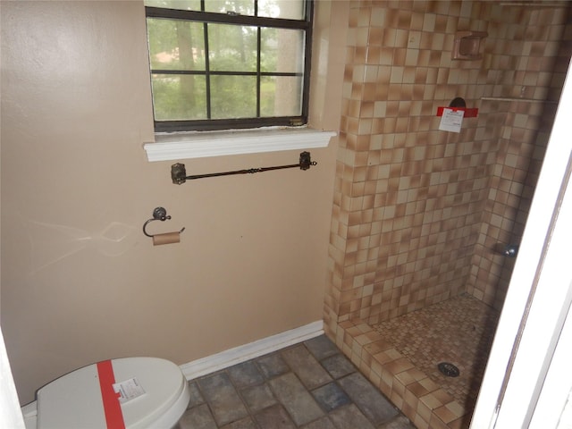 9217 Rhett Cir, Shreveport, LA 71118 - bathroom featuring a shower stall, baseboards, stone finish flooring, and toilet