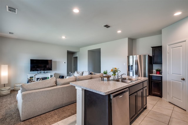 16421 Porterfield Ln, Justin, TX 76247 - kitchen featuring a sink, stainless steel appliances, light countertops, open floor plan, and light tile patterned floors