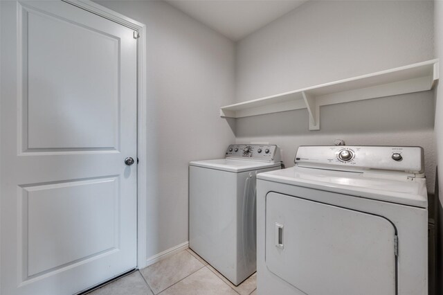 16421 Porterfield Ln, Justin, TX 76247 - laundry room featuring washer and dryer, light tile patterned flooring, and baseboards