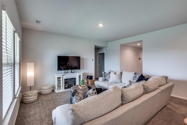 16421 Porterfield Ln, Justin, TX 76247 - carpeted living room with a glass covered fireplace, baseboards, and recessed lighting