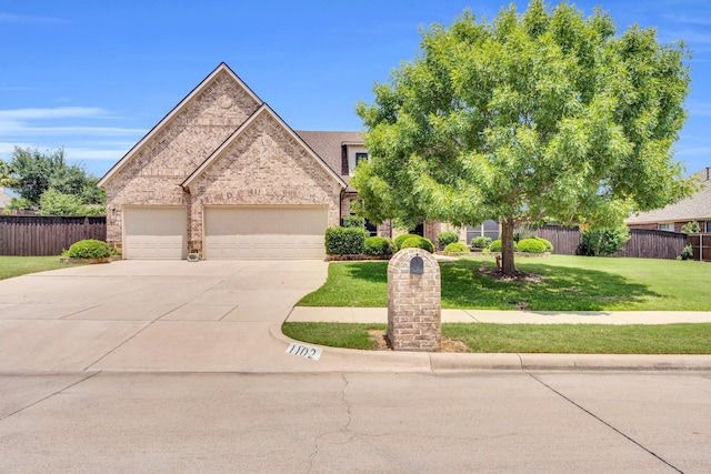 1102 Sunland Ct, Mansfield, TX 76063 - view of front facade with driveway, an attached garage, and brick siding