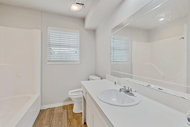 914 Glengarden St, Krum, TX 76249 - bathroom with toilet, plenty of natural light, vanity, and wood finished floors