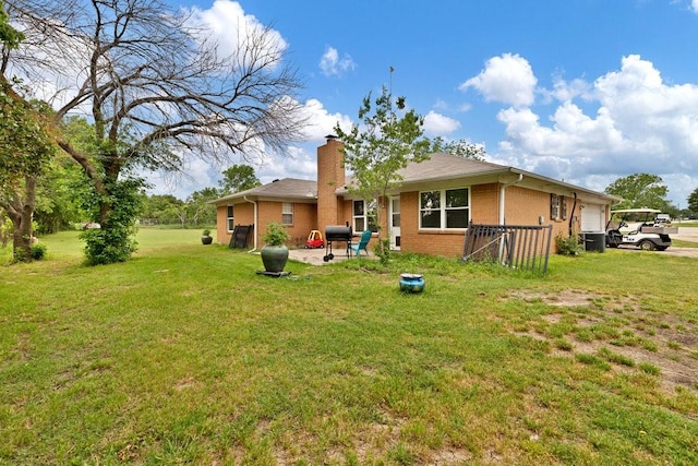 914 Glengarden St, Krum, TX 76249 - back of property with a chimney, brick siding, and a yard