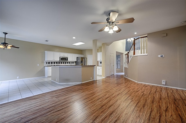 1503 Murphy Dr, Rockwall, TX 75087 - unfurnished living room featuring ceiling fan, light wood-style floors, stairs, and baseboards