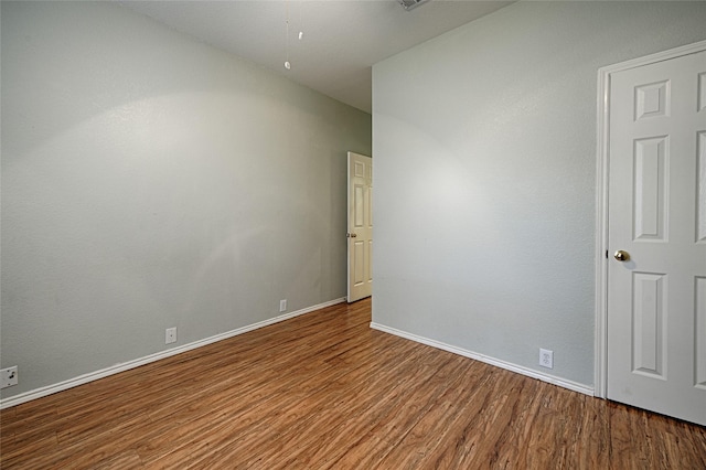 1503 Murphy Dr, Rockwall, TX 75087 - spare room featuring wood finished floors, baseboards, and attic access