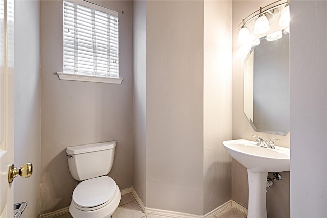 1503 Murphy Dr, Rockwall, TX 75087 - half bathroom featuring toilet, baseboards, and a sink