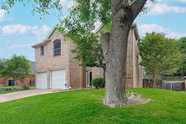 1503 Murphy Dr, Rockwall, TX 75087 - traditional home with a garage, driveway, brick siding, and central AC unit