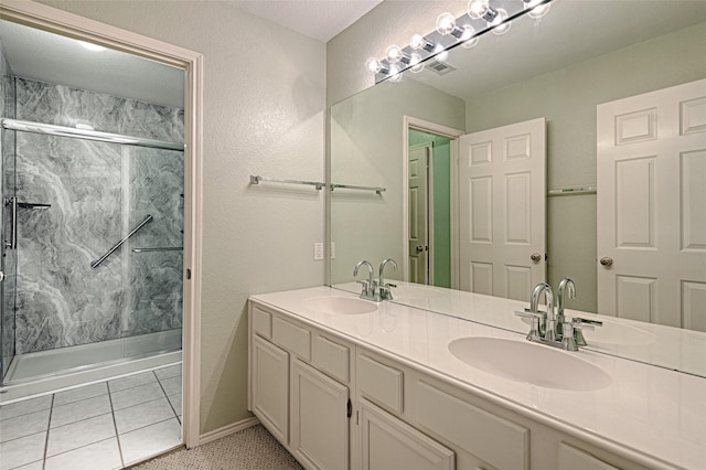 1503 Murphy Dr, Rockwall, TX 75087 - bathroom with a marble finish shower, double vanity, and tile patterned floors