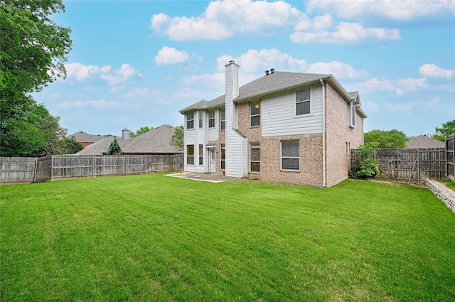1503 Murphy Dr, Rockwall, TX 75087 - rear view of house with a chimney, a patio area, and brick siding