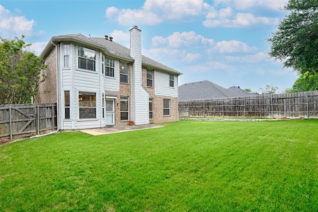1503 Murphy Dr, Rockwall, TX 75087 - rear view of house featuring brick siding, a chimney, and a patio