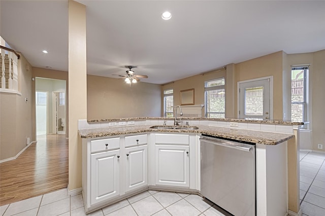 1503 Murphy Dr, Rockwall, TX 75087 - kitchen with dishwasher, a sink, a ceiling fan, light stone countertops, and white cabinets