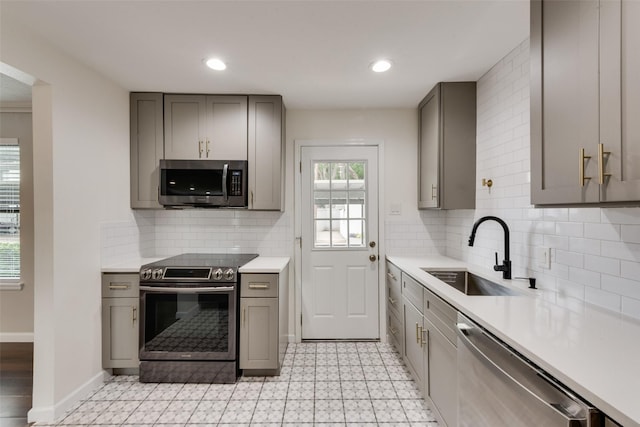 5010 Lahoma St, Dallas, TX 75235 - kitchen featuring appliances with stainless steel finishes, gray cabinets, a sink, light countertops, and light floors