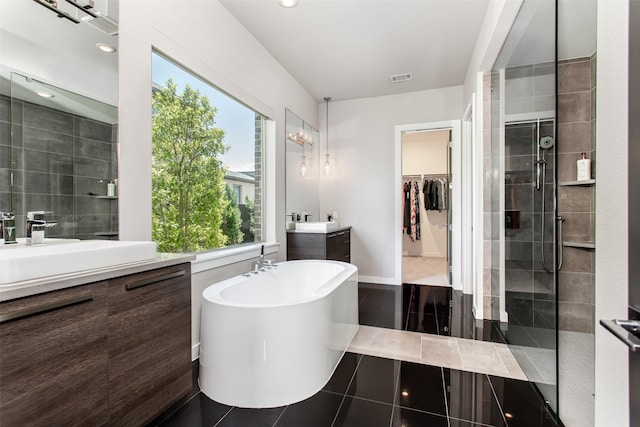 2468 Electra Dr, Allen, TX 75013 - full bath featuring two vanities, a soaking tub, a shower stall, a spacious closet, and tile patterned floors