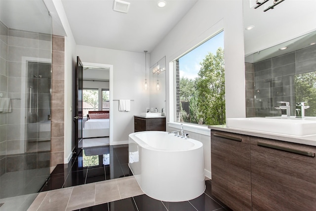 2468 Electra Dr, Allen, TX 75013 - bathroom with two vanities, a freestanding bath, ensuite bathroom, recessed lighting, and tiled shower