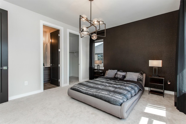 2468 Electra Dr, Allen, TX 75013 - carpeted bedroom featuring a chandelier, a spacious closet, a closet, baseboards, and ensuite bath